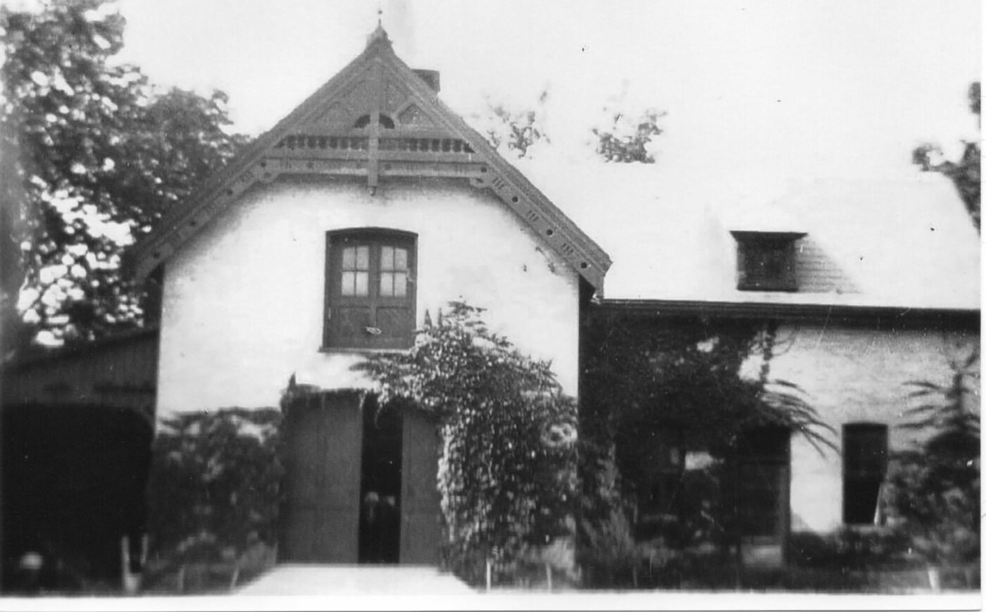 A historic photograph of the white-gabled Gore coach house