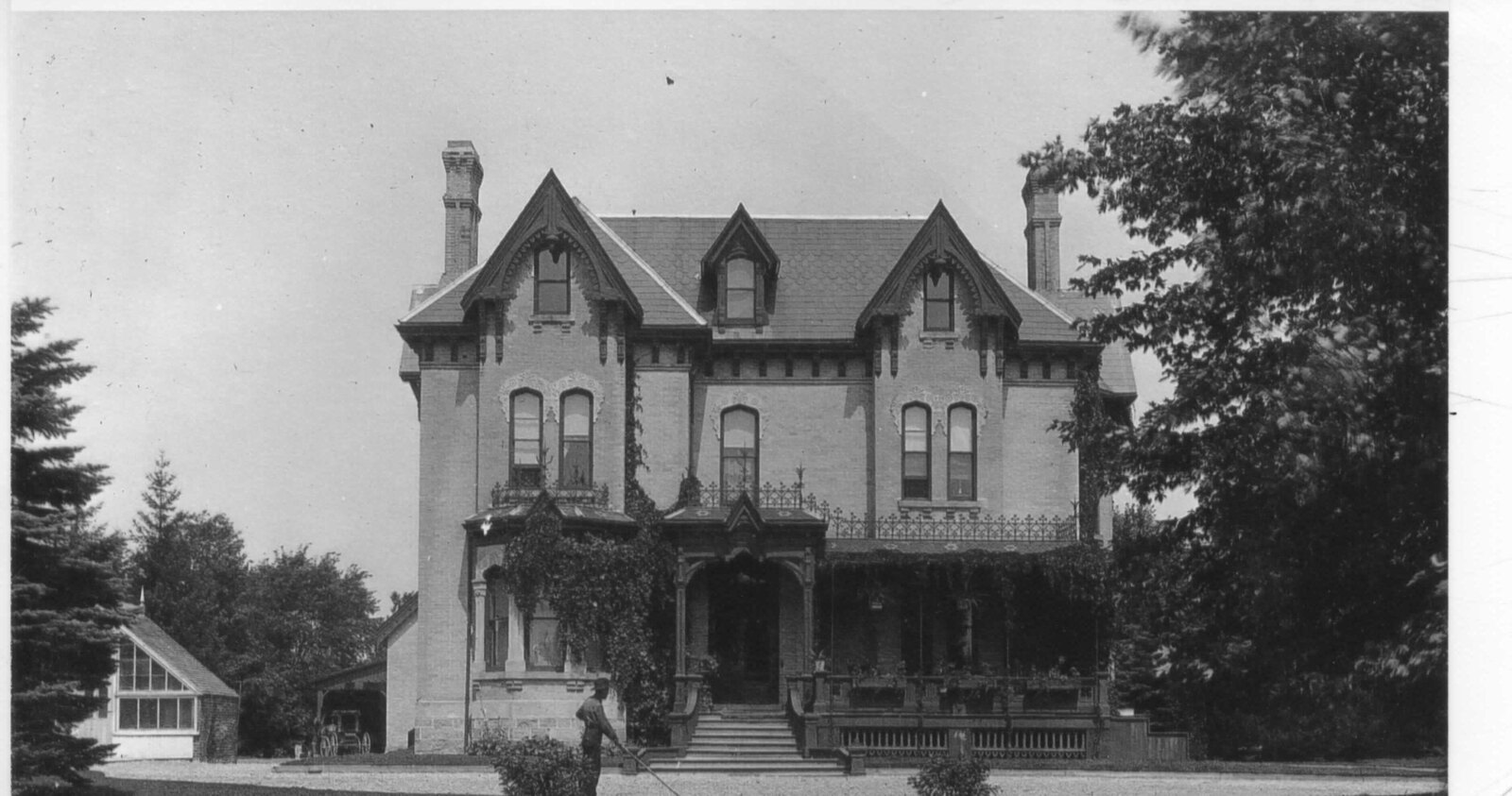 The Gore mansion front facade with figures and a conservatory