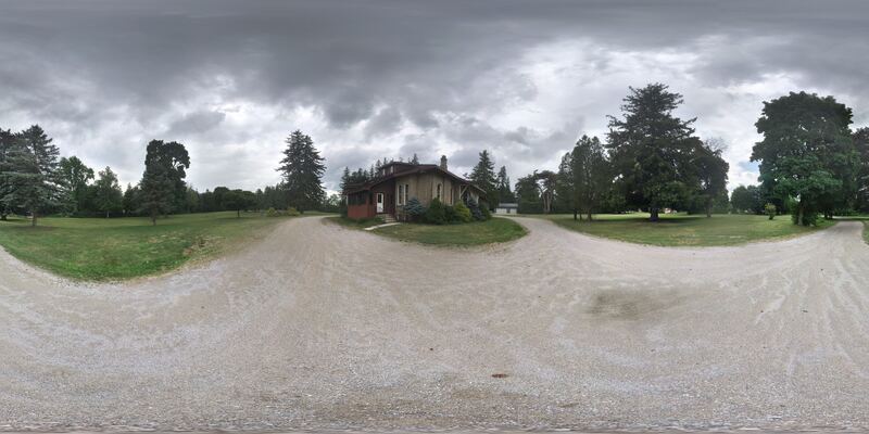 360° view from the driveway toward the house under an overcast sky
